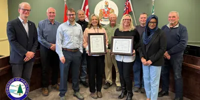 Township of Hamilton staff posing with Distinguished Budget Presentation Award for 2025 in council chambers